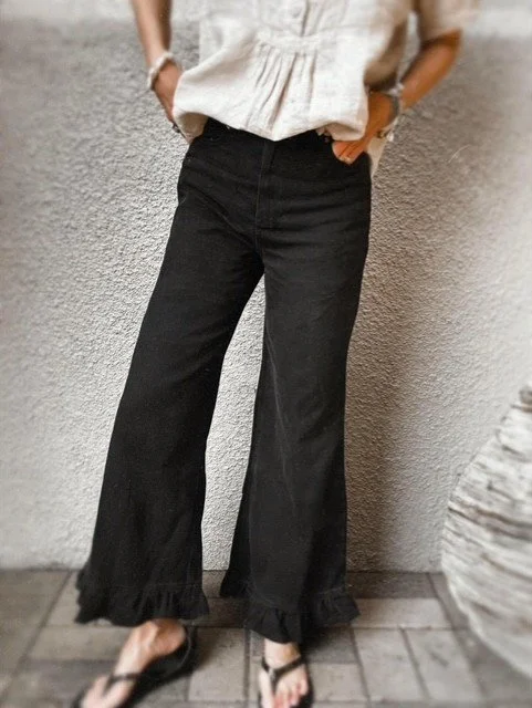 Women’s black jeans with feminine ruffle hem detail