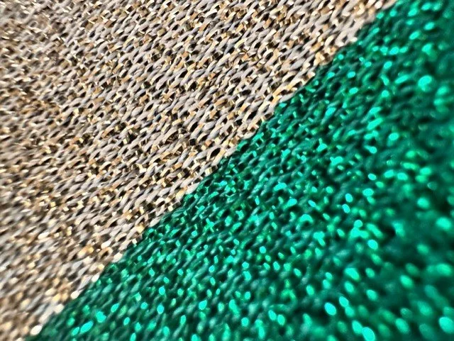 Close-up of women's gold heart clasp belt with green ribbon detail