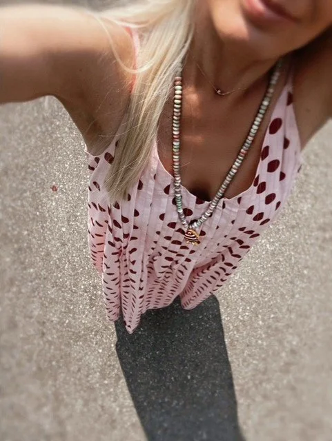 Pink and white beaded necklace with red fish pendant