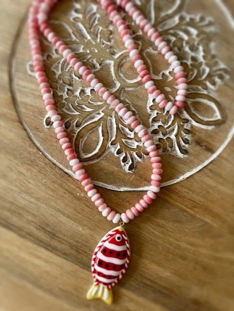 Pink and white beaded necklace with red & white fish pendant