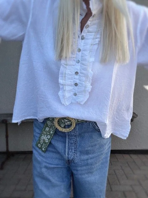 Close-up of the gold beaded buckle on the green floral belt.