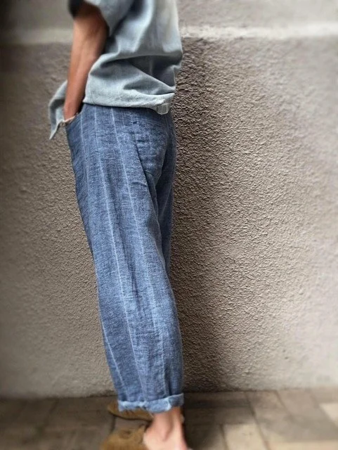 Side view of the Banditas Agnan Linen Pants in mid-blue with cuffed hem.
