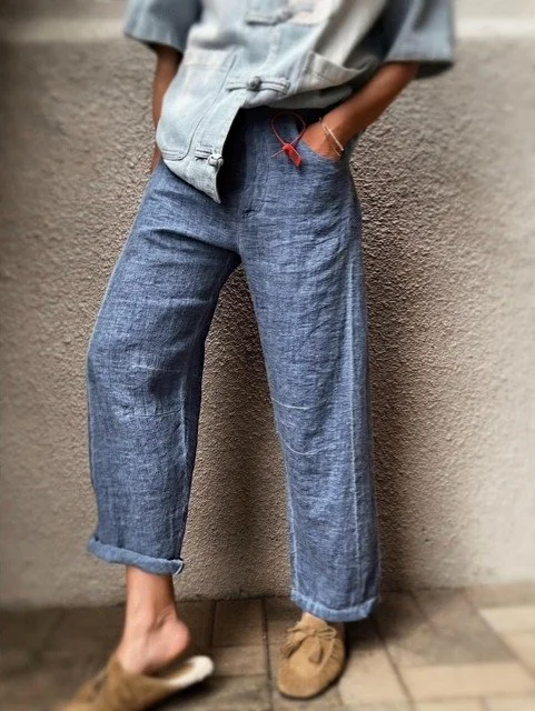 Banditas Agnan Linen Pants in blue, high waist and easy linen drape against a textured wall.
