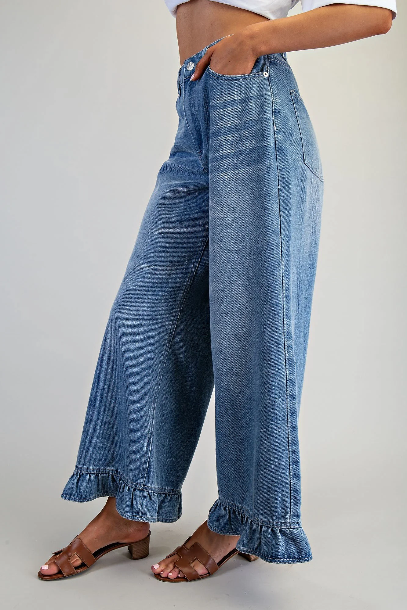 Blue high-waisted jeans with flared frill hem