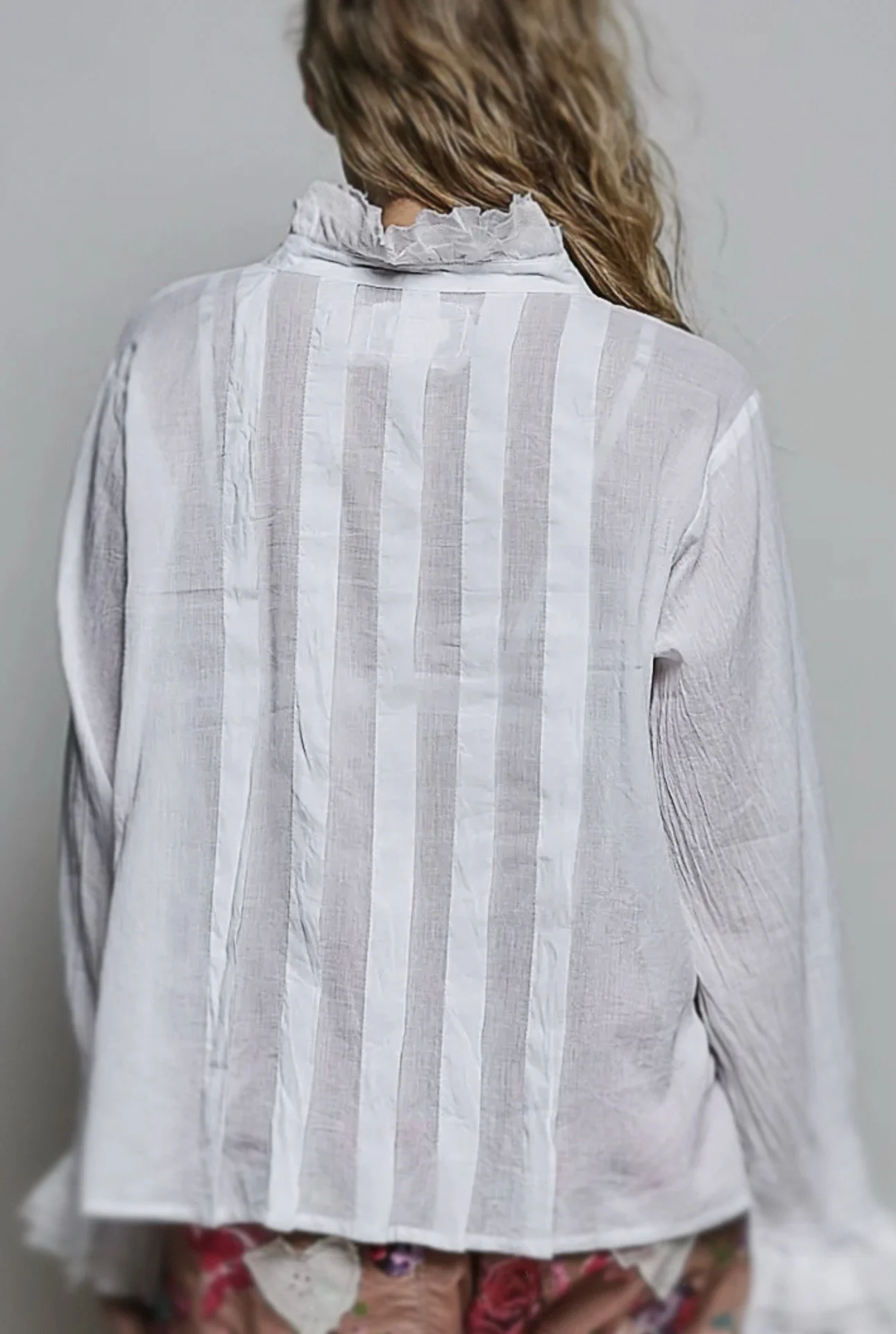 Back view of the white blouse showing vertical textured panels.