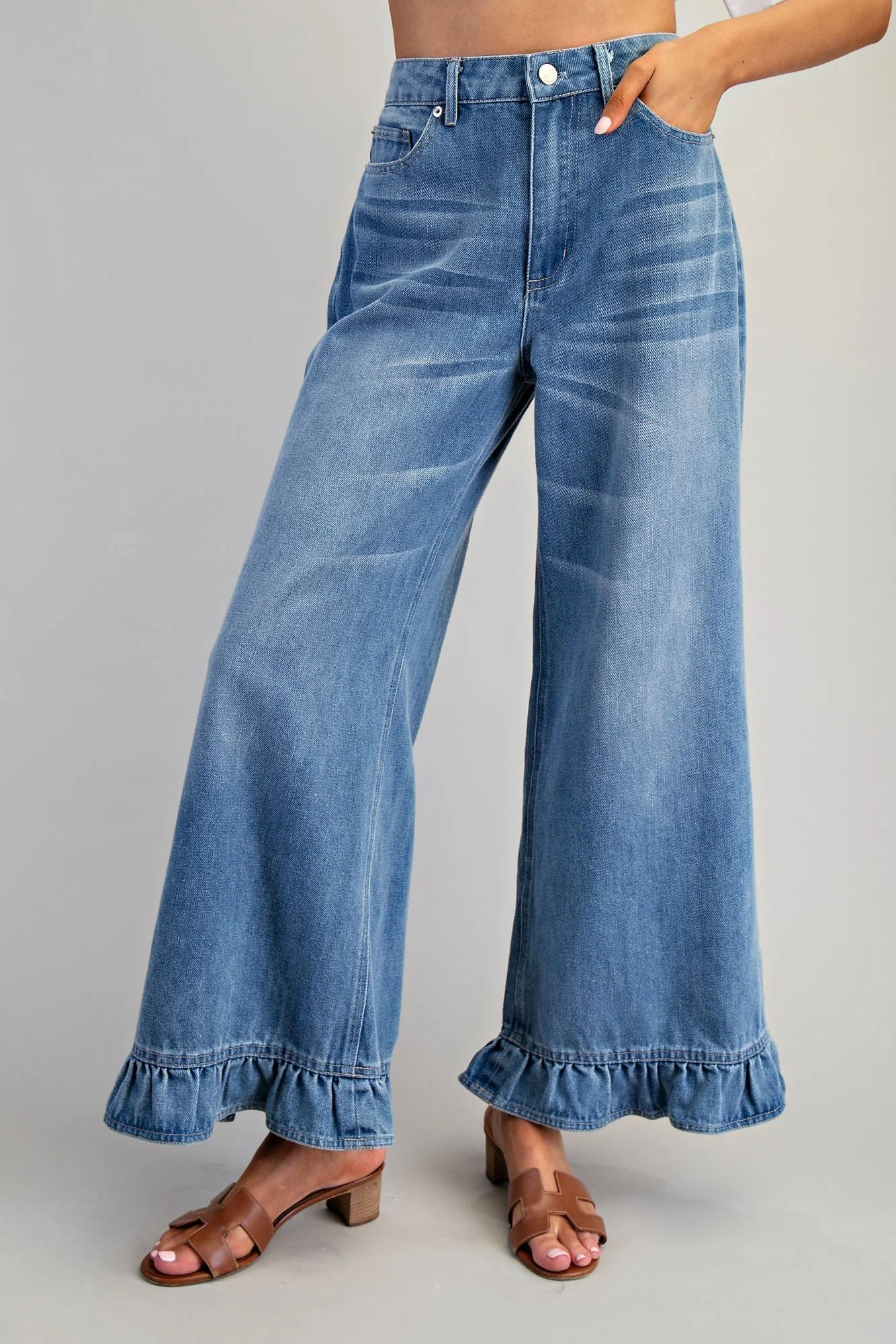 Blue wide-leg jeans with frill hem styled with a beige linen blouse