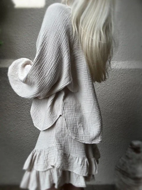 Side view of the Capri Ruffle Skirt in soft beige cotton gauze.