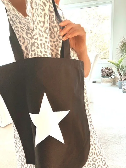 Close-up of custom star design on women's cotton canvas tote bag
