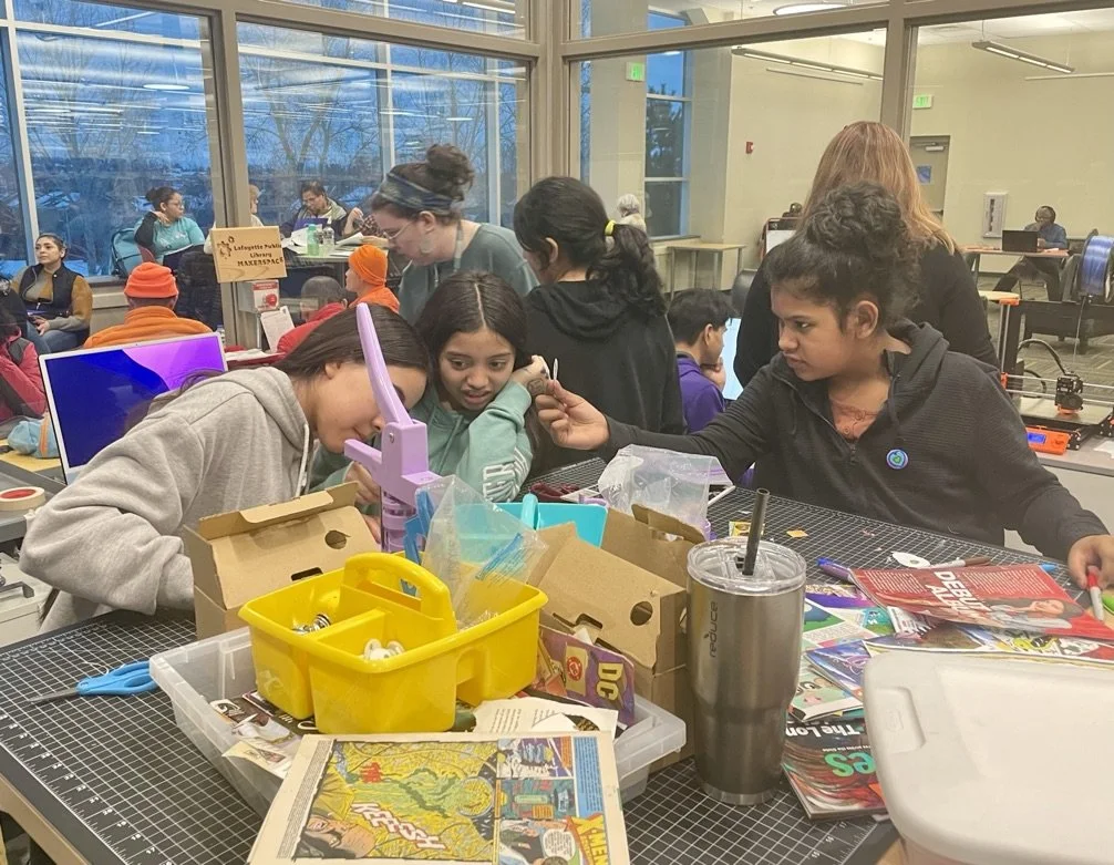Teen girls at a table working on a craft.jpeg