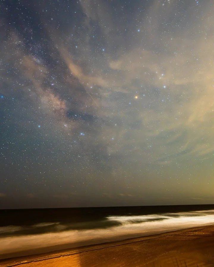 Hours under the stars condensed into a moment. The Milky Way drifting over the coast of Surf City, NC 🌌 I was shocked that the Milky Way was even visible there since the Wilmington area has pretty heavy light pollution. Had some fun light painting w