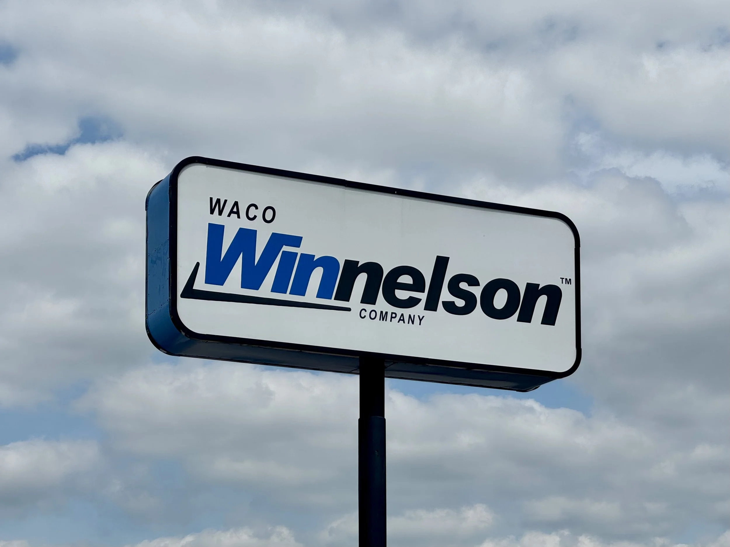 A sign for Wyndham in Waco, Texas, against a cloudy sky.