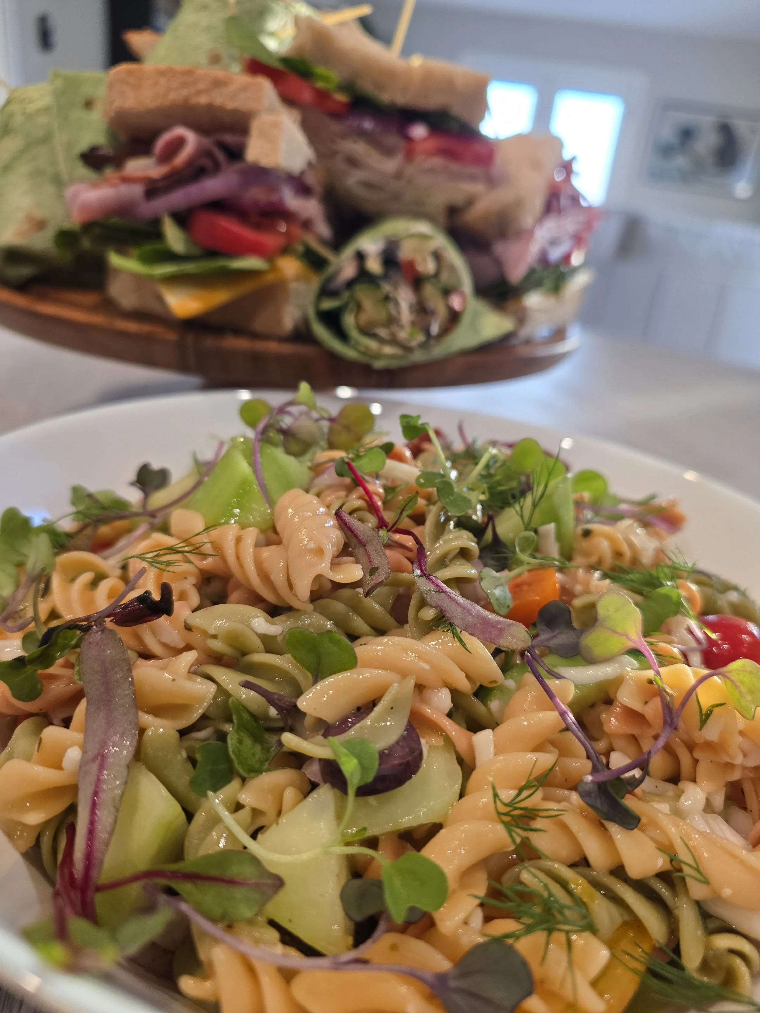 Close-up of a pasta salad with microgreens on top.