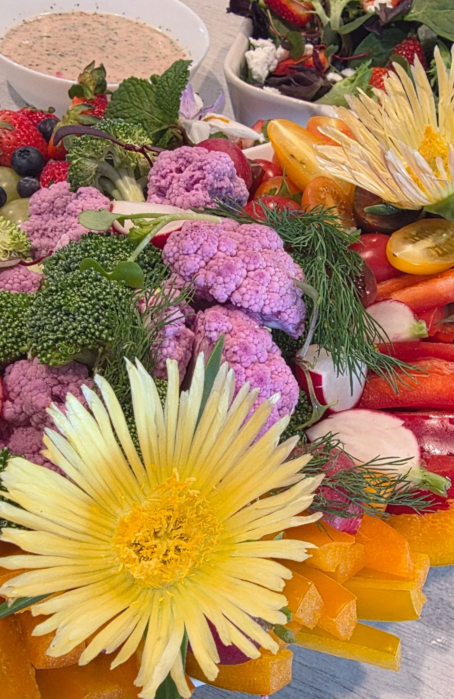 Colorful crudite platter with a berry salad