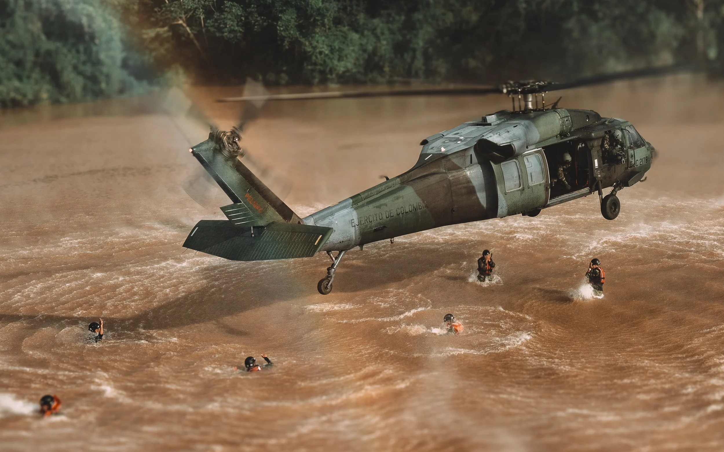 Helicopter low over a river during a water rescue