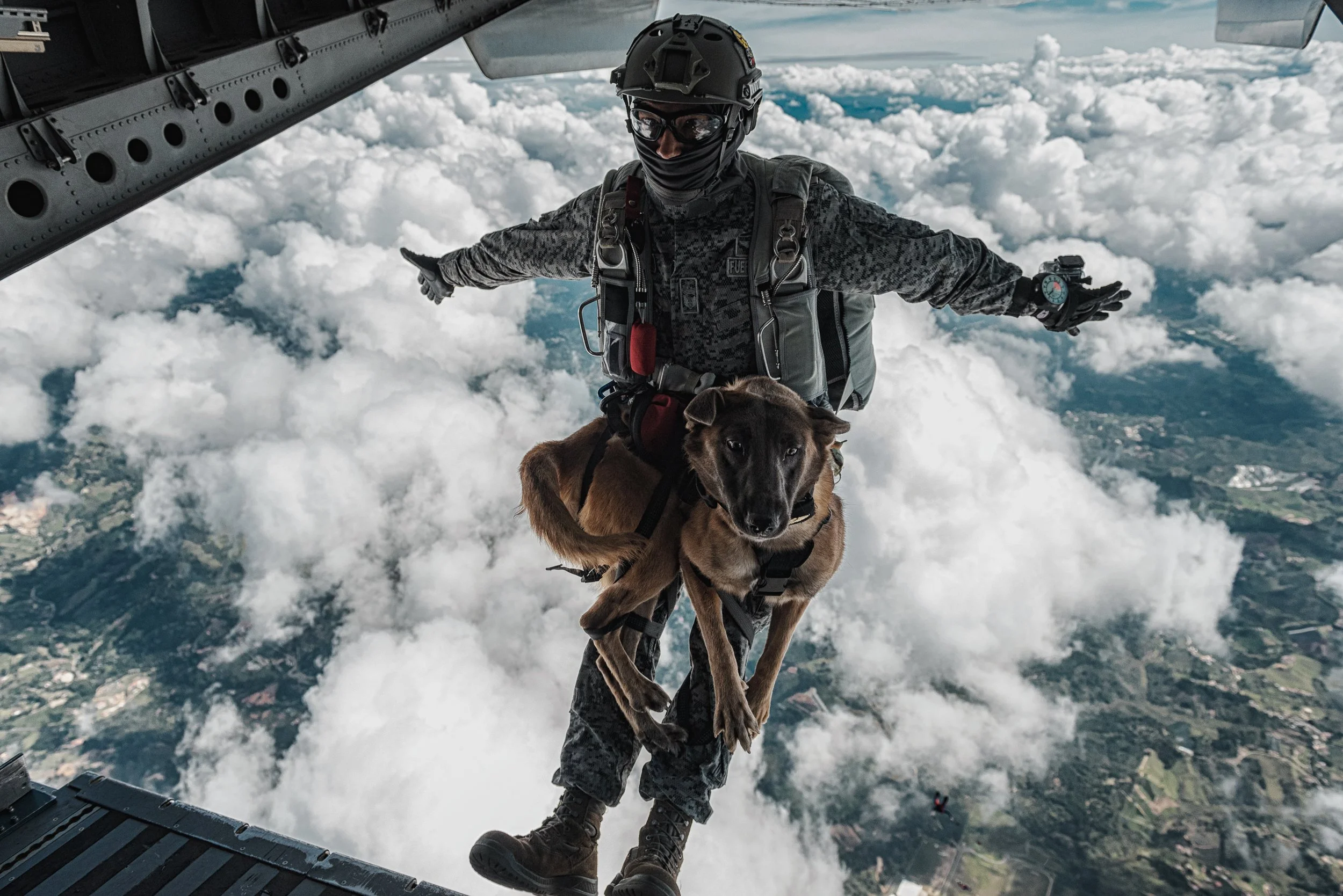Jumpmaster at the open ramp above the clouds