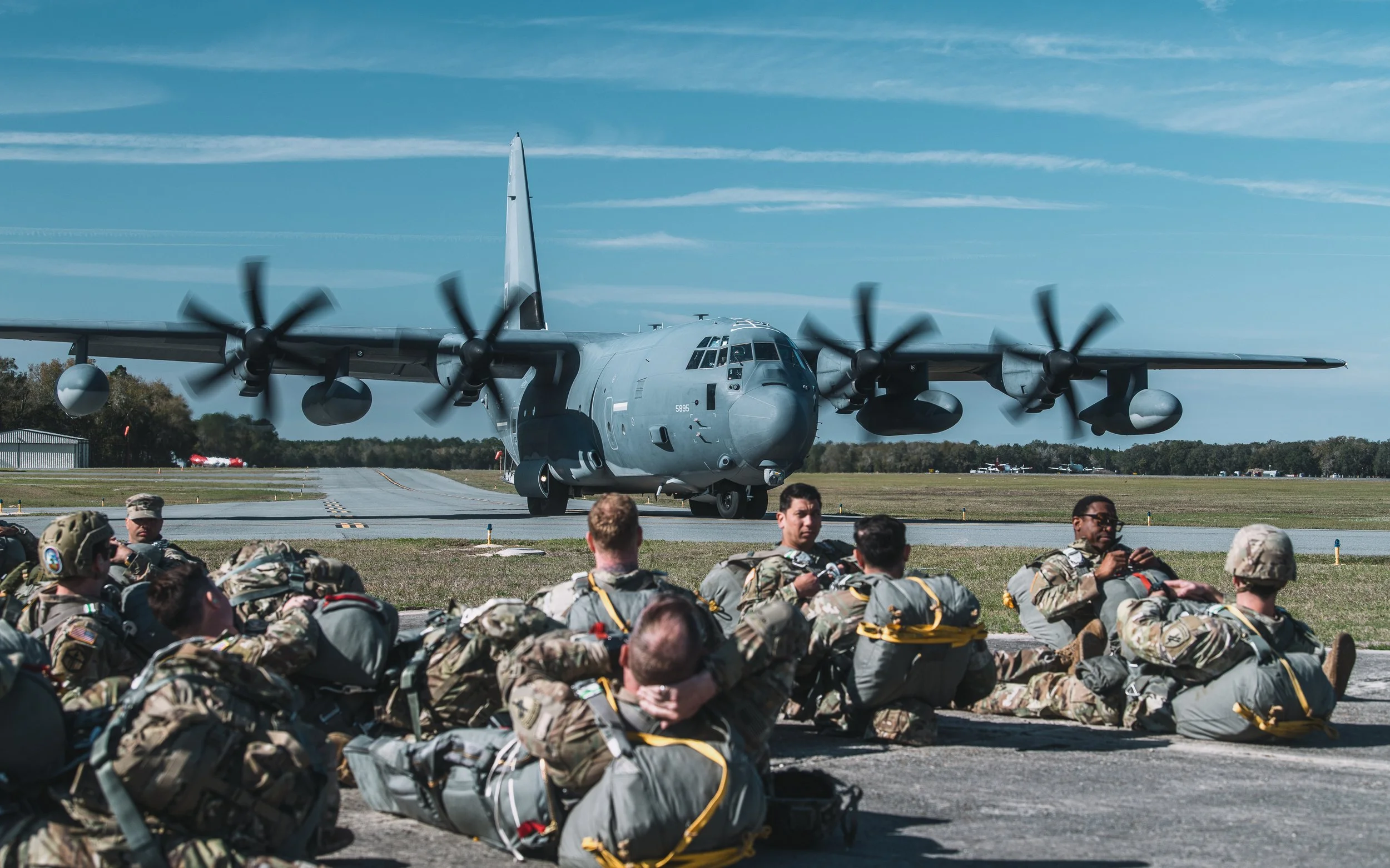 Paratroopers waiting beside a transport aircraft