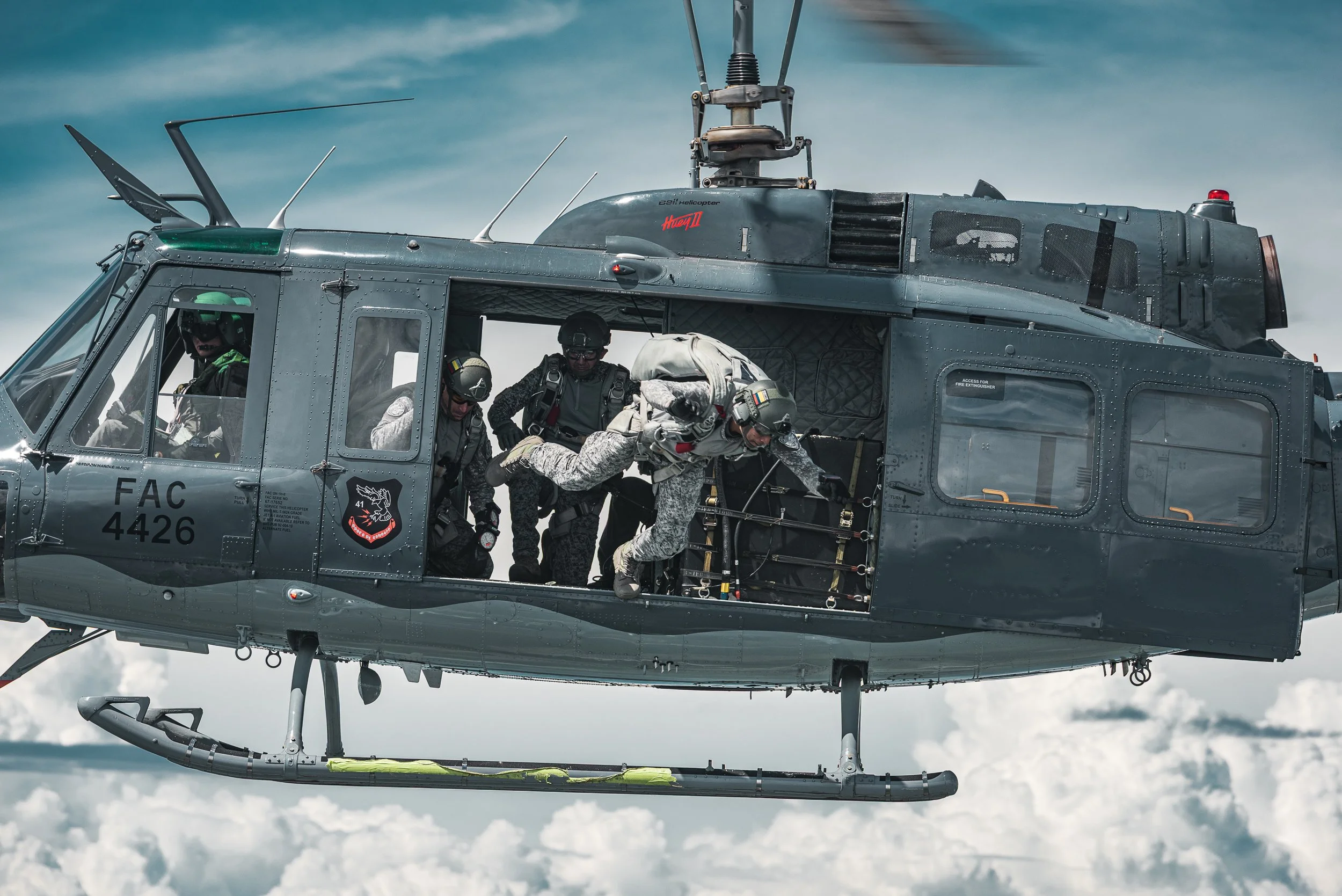 Crew at the open door of a helicopter in flight