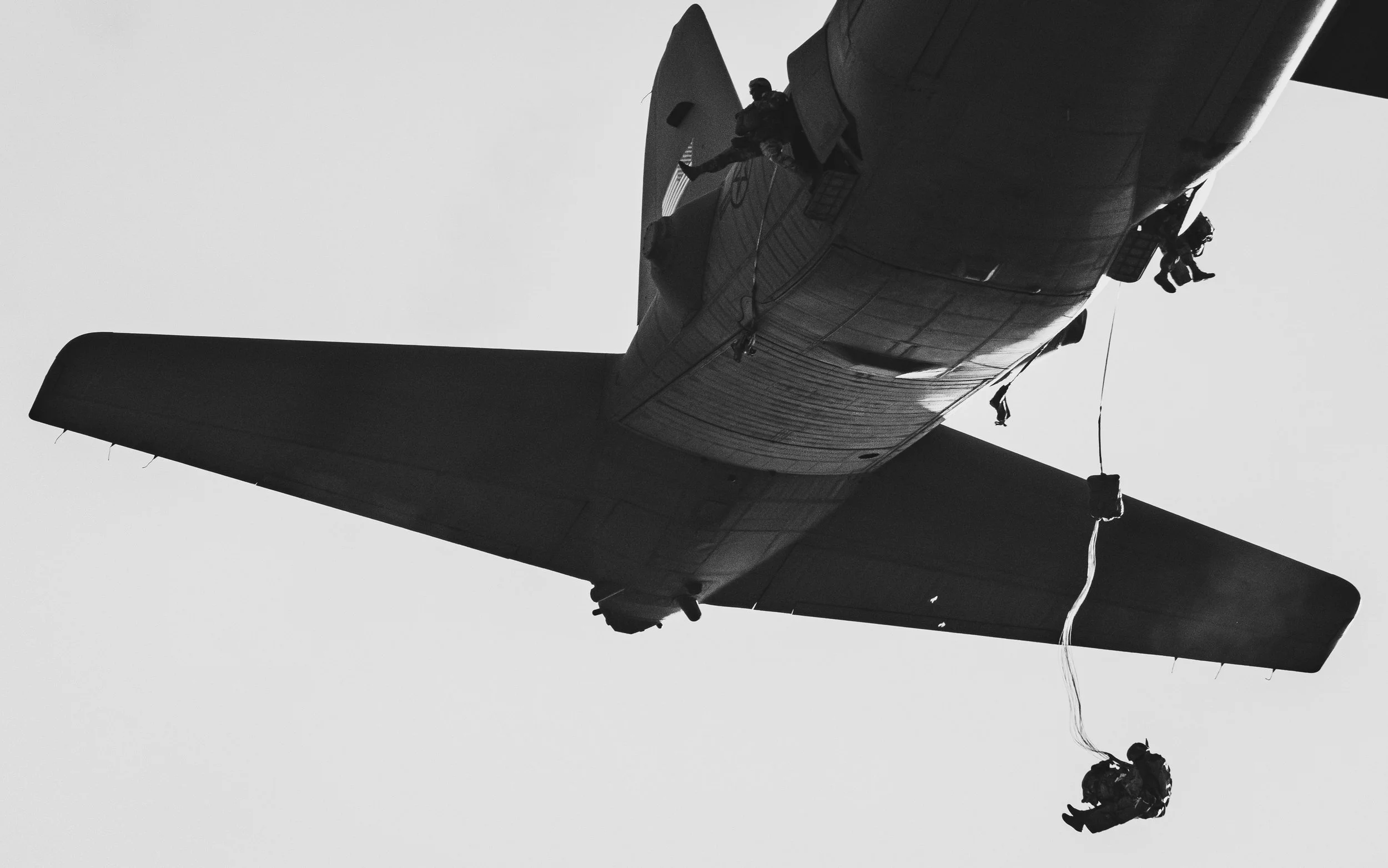 Aircraft overhead with a jumper on a line