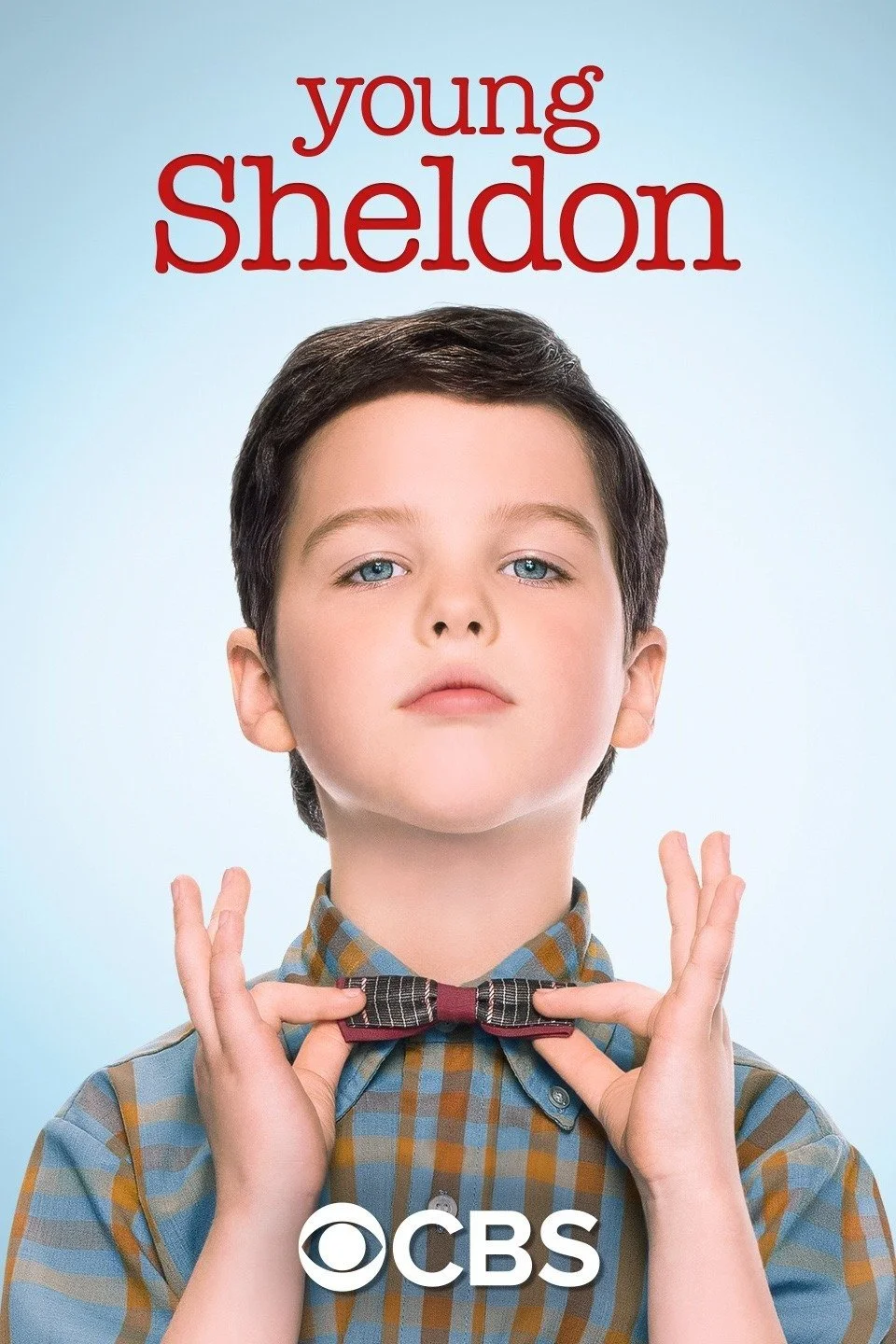 Poster for the TV show 'Young Sheldon' featuring a young boy with dark hair, blue eyes, and a confident expression, adjusting his bow tie against a light background. The title 'Young Sheldon' is displayed in red above his head with the CBS logo at the bottom.