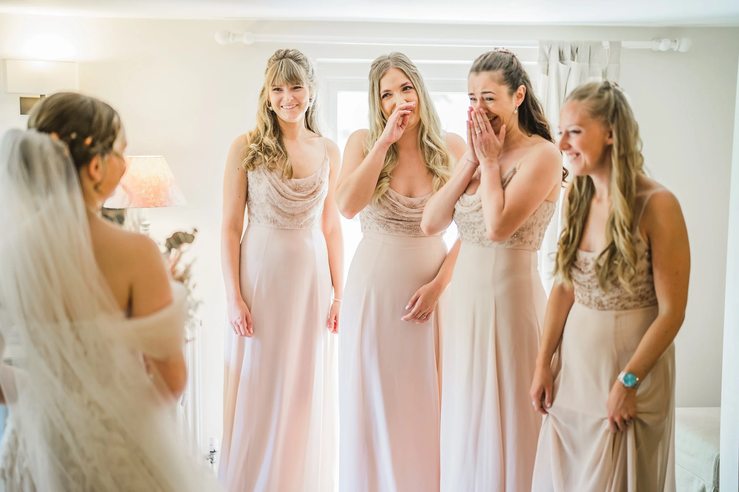 Bride getting revealed to the bridesmaids