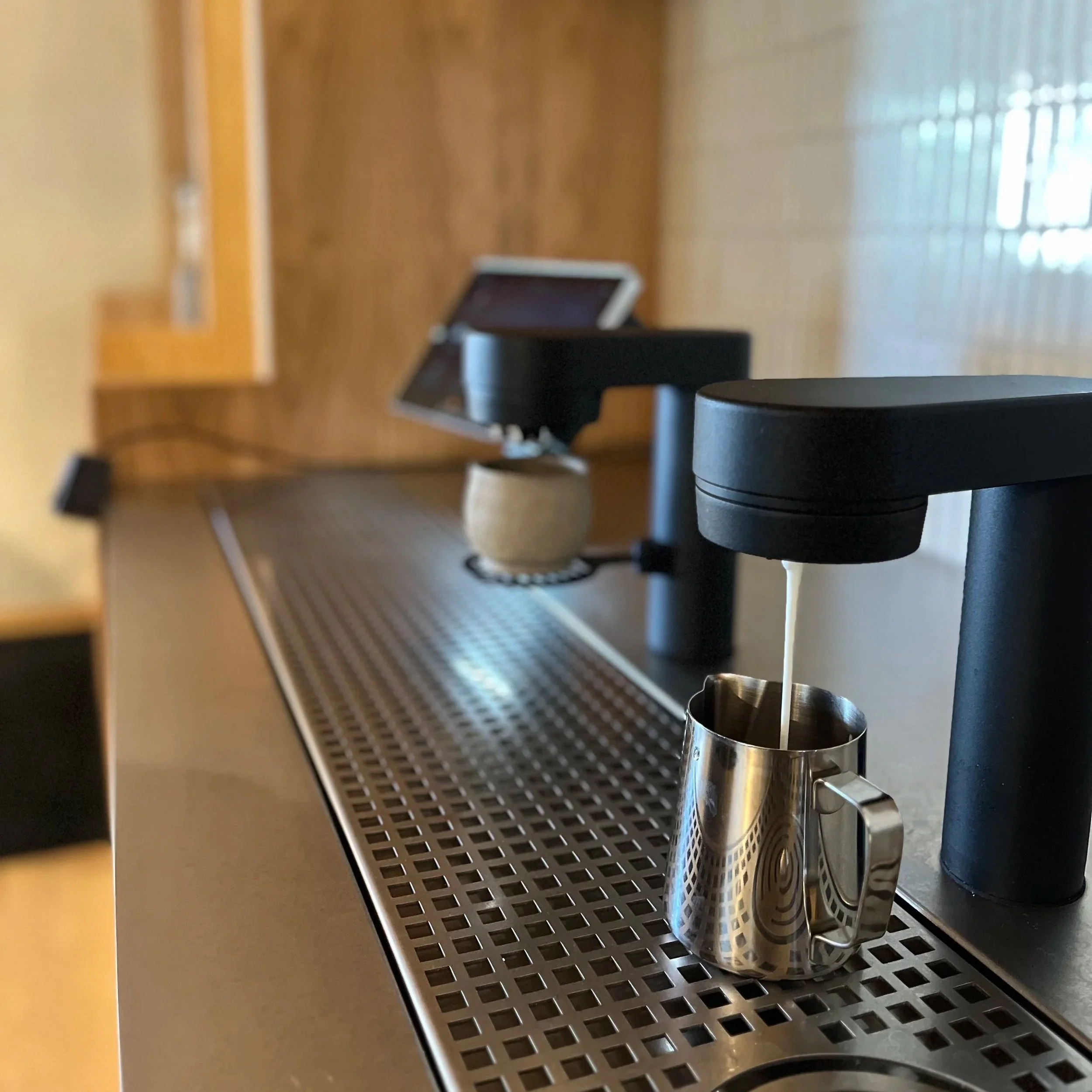 SPECTER coffee system dispensing milk into a stainless-steel pitcher at Restaurant BARR.