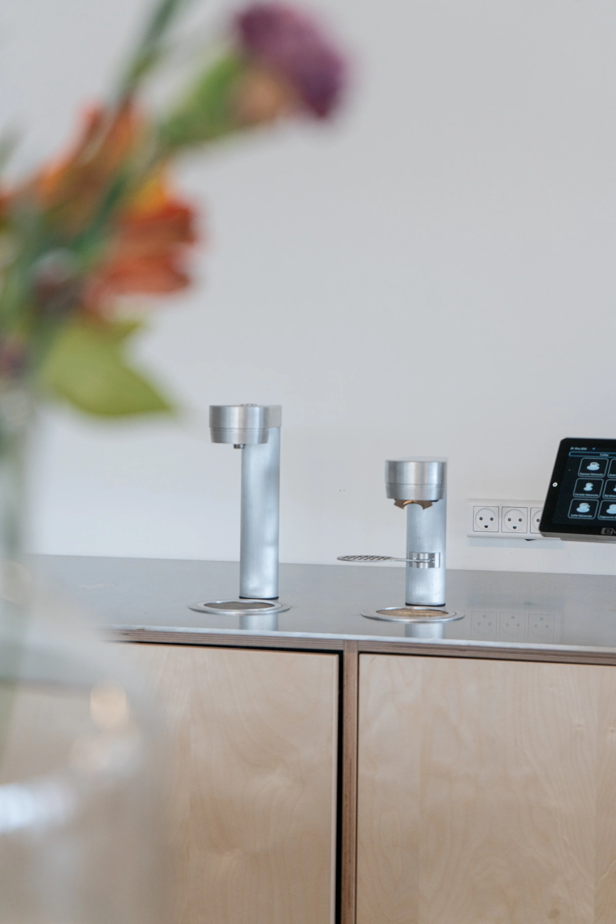 An under counter coffee solution integrated into an architect office with a kitchen made of a wooden cabinet