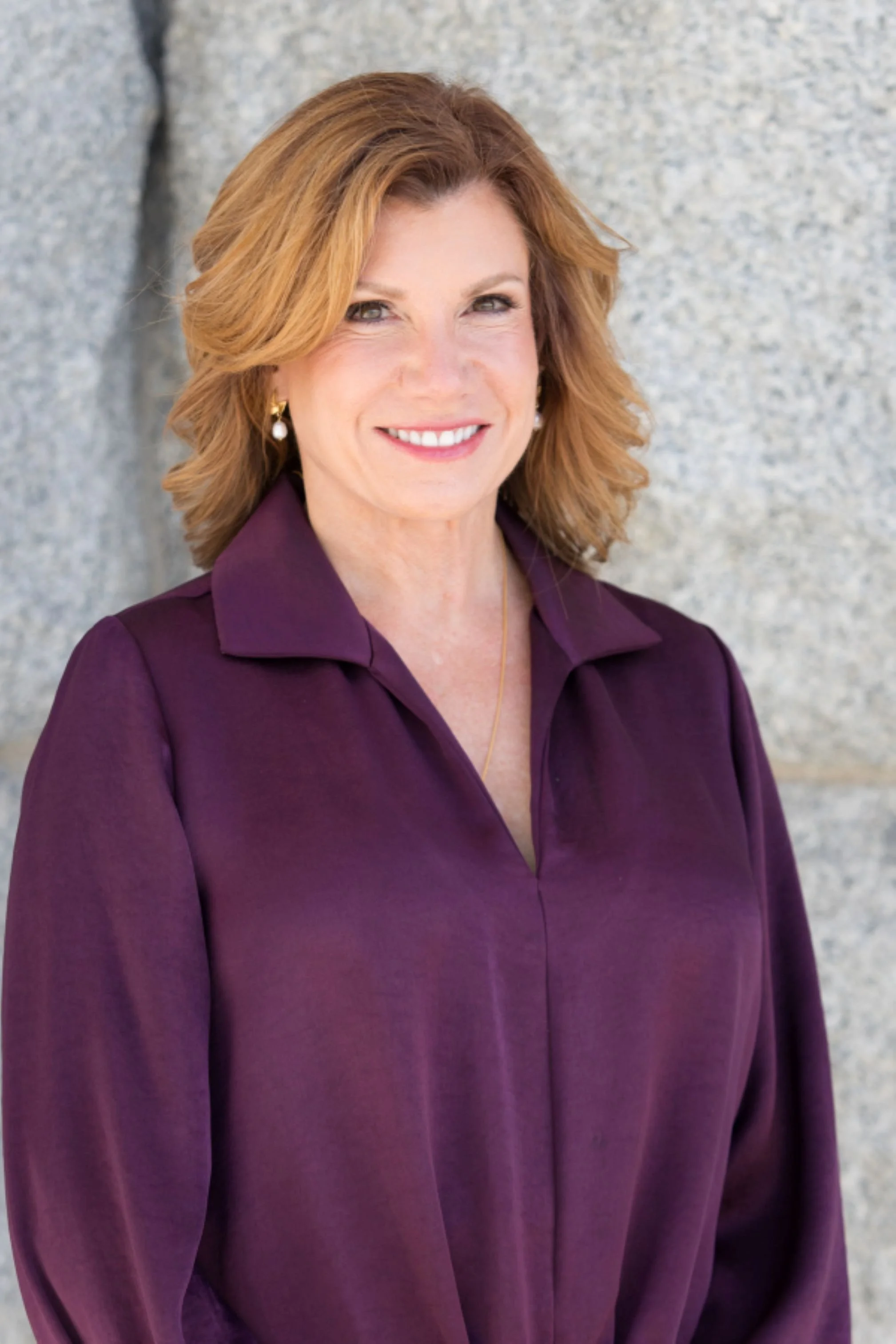 headshot of maureen farrell in purple blouse smiling outside