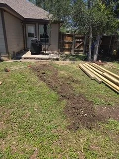The original backyard before construction. The homeowner wanted to replace this underutilized lawn with a functional deck and a clear walkway to the firepit area.