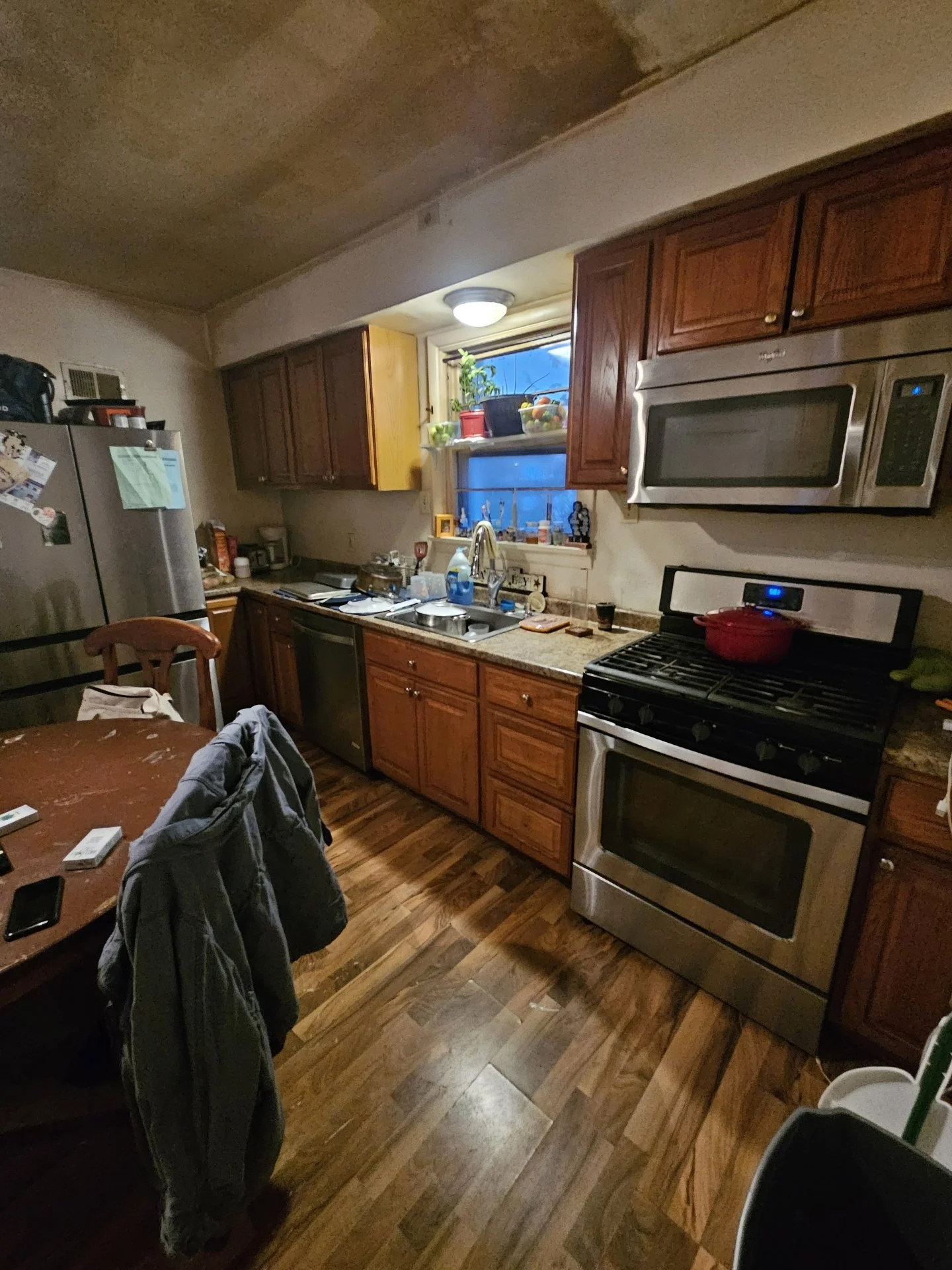 Before: Dark cabinets and worn floors made the kitchen feel heavy and closed-in.