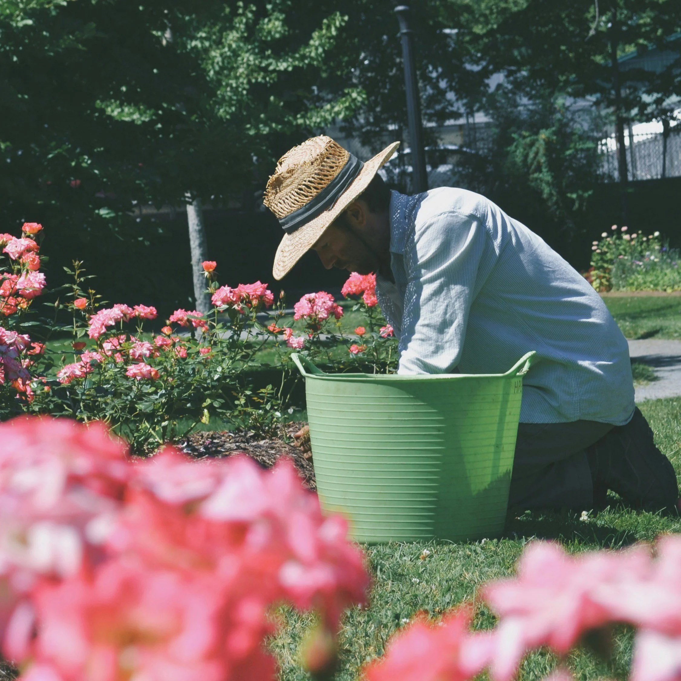Man wearing a wide-brimmed straw hat for sun protection while doing yardwork in Mississippi.