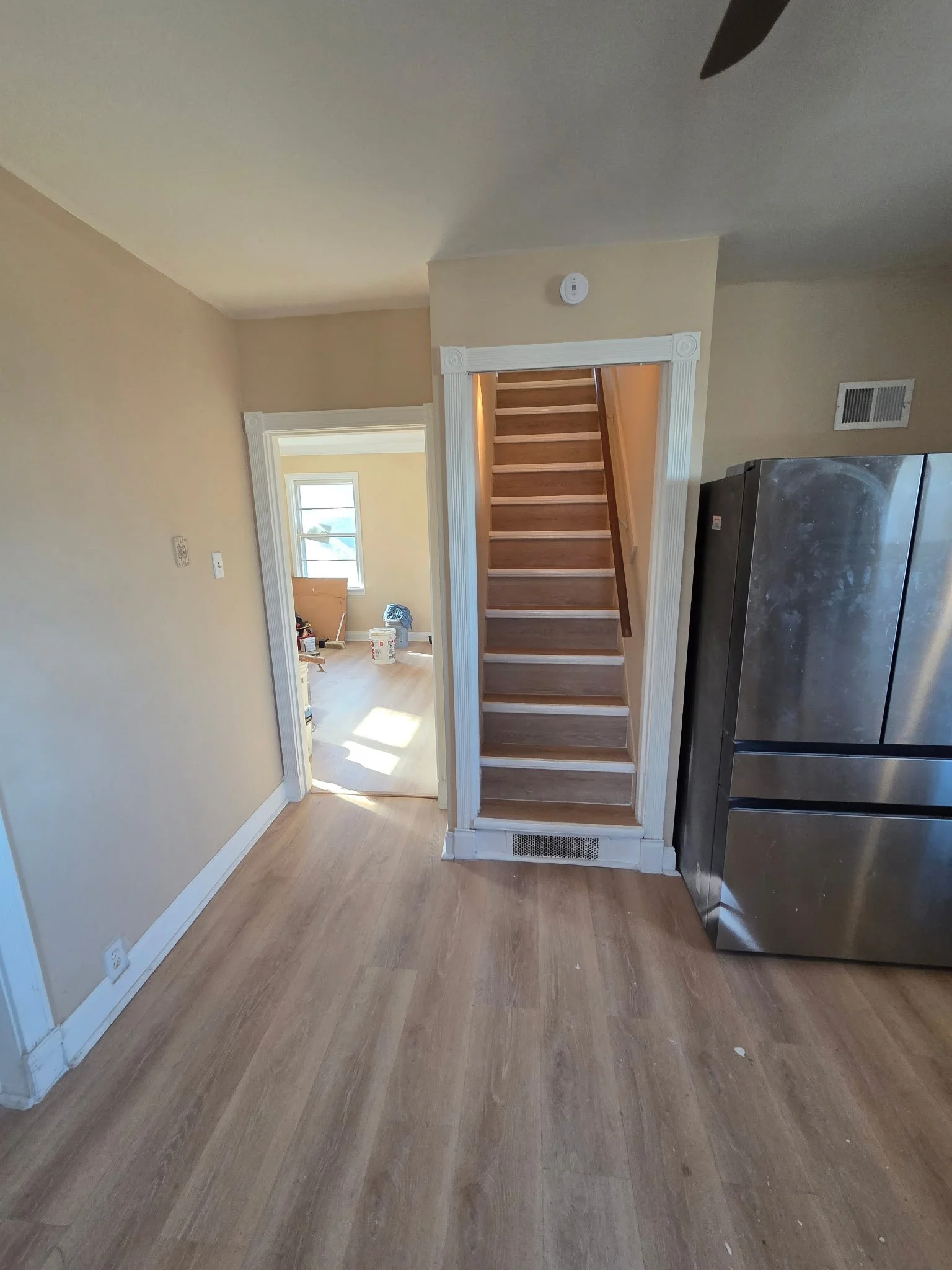 After: Light tones and smart finishes create an open, breezy, and welcoming ascent.