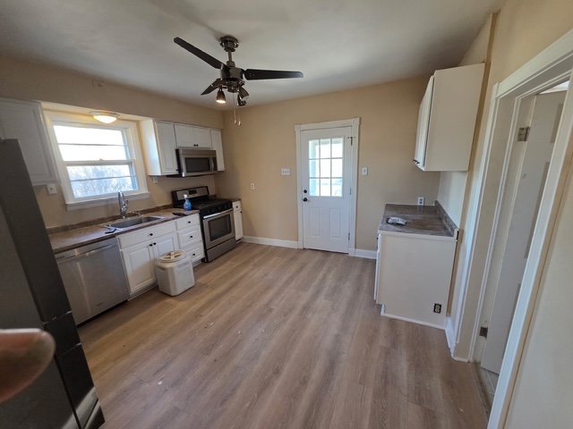 After: Bright walls and flawless modern flooring bounce light into every corner. The Transformation: Maximized brightness and clean lines for a fresh, spacious feel.