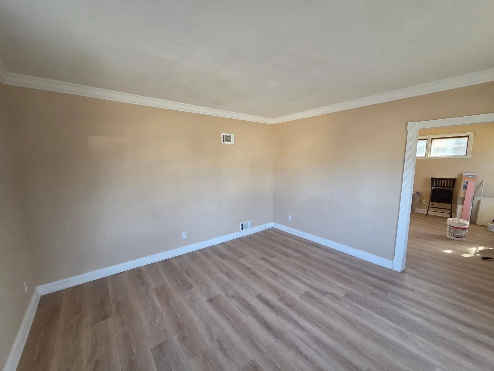 After: Seamless new flooring paired with crisp paint bounces light effortlessly into every corner.