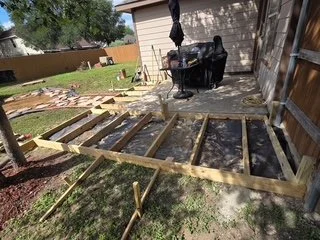 Framing the new deck using premium pressure-treated lumber for maximum durability and long-term safety.
