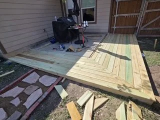 Finishing details on this custom deck installation, designed to wrap seamlessly around the existing patio.