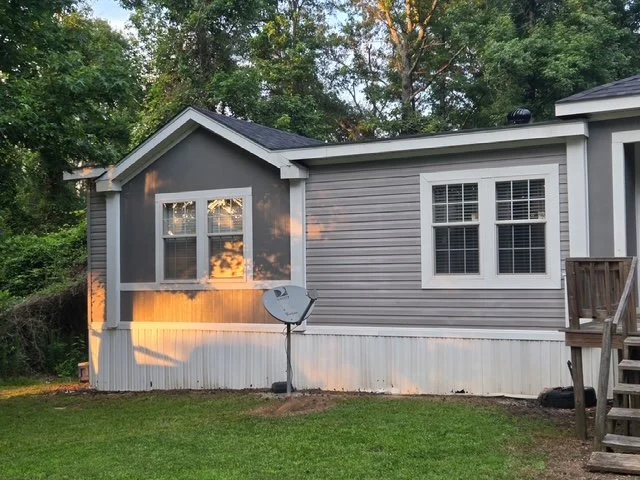 A stunning transformation—our soft-wash system completely eliminated the green staining to bring back a crisp, clean white.