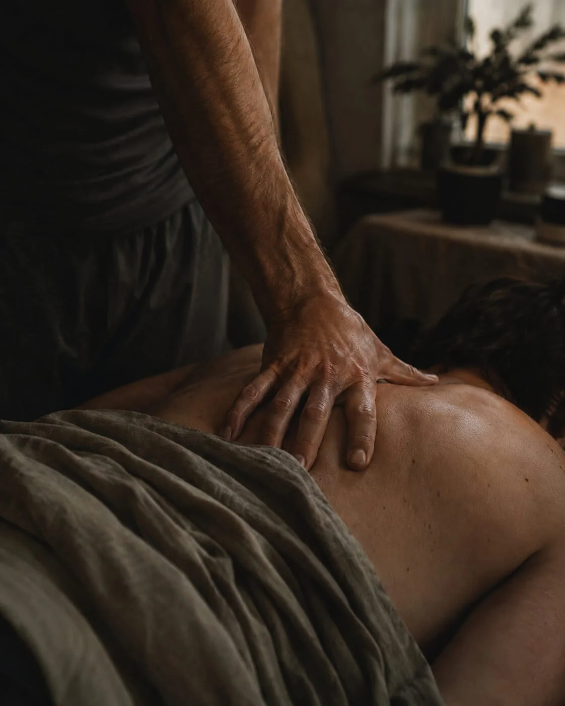 Hands applying pressure to a person’s back during massage