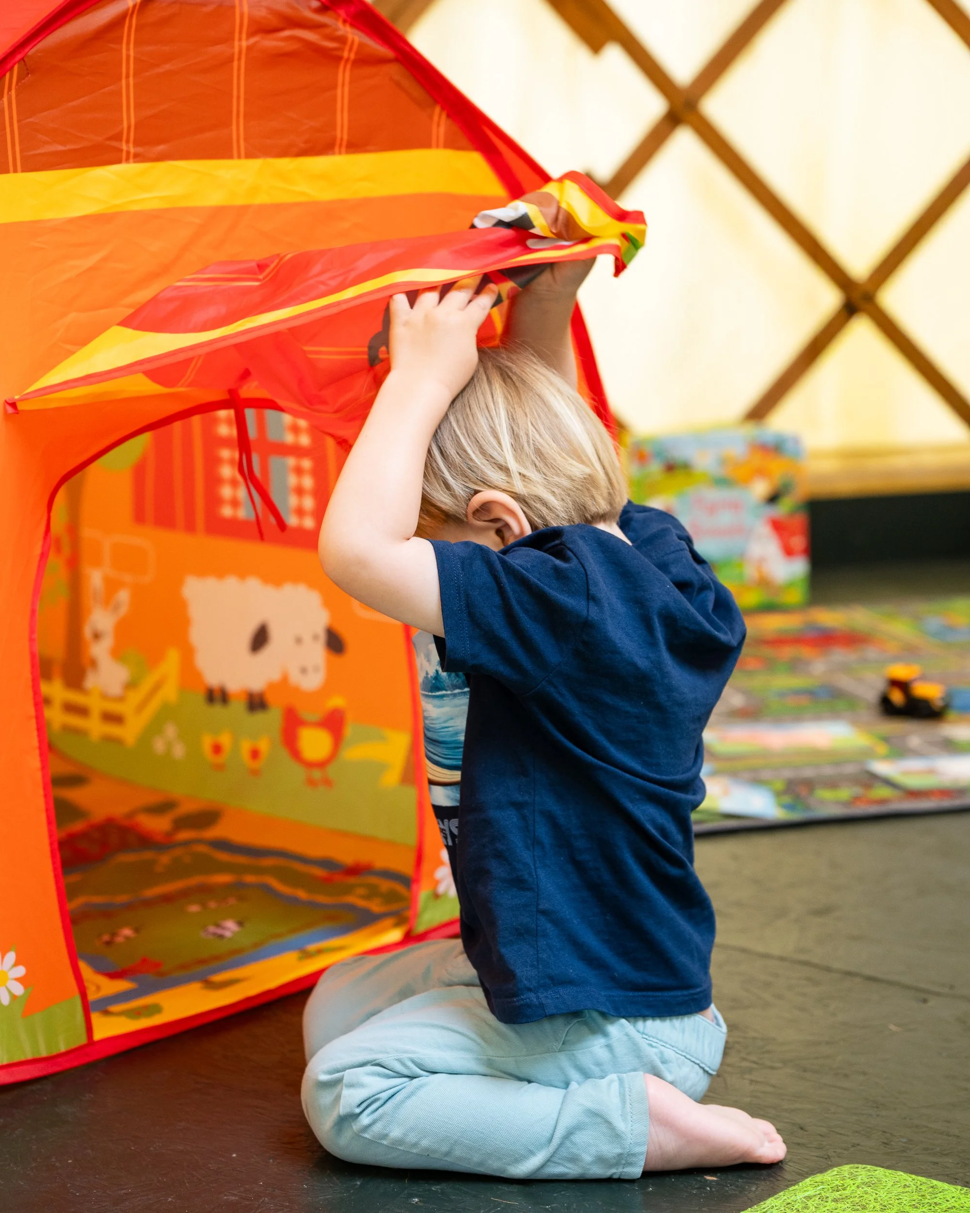 toddler playing in a tent during family photoshoot in worcestershire