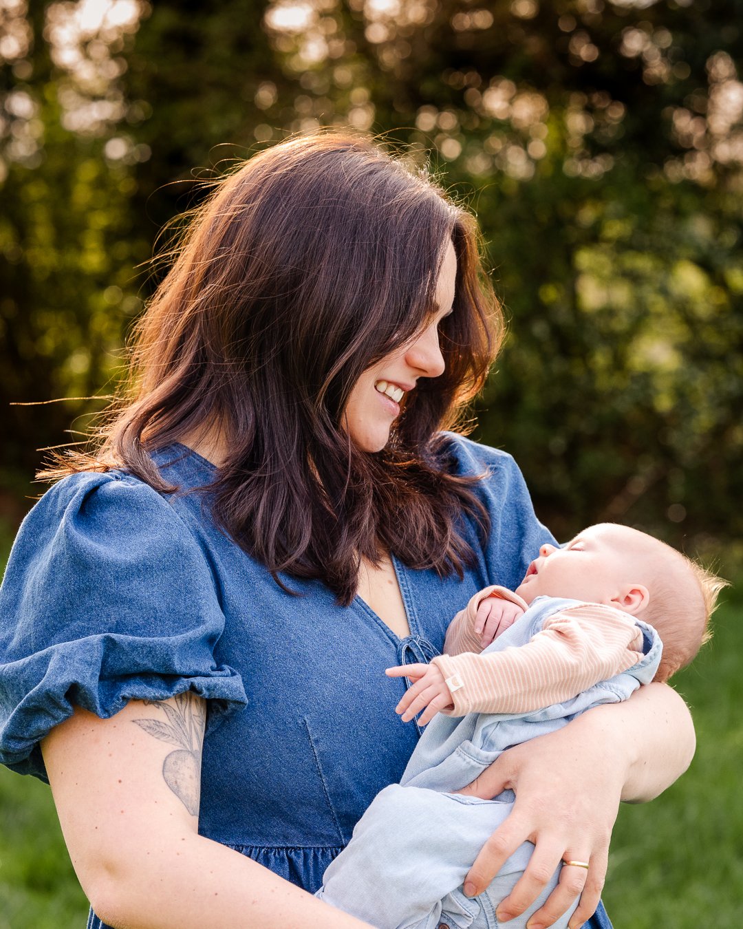 Mother holding baby during family outdoor photoshoot