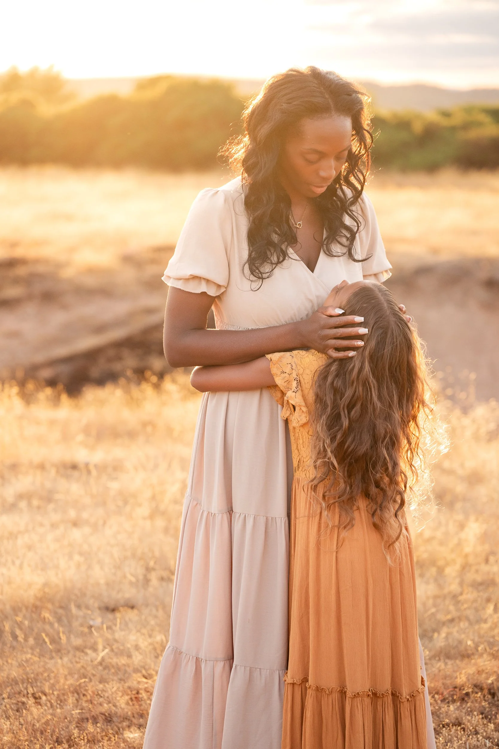 mum and daughter embracing during sunset family photoshoot in worcester