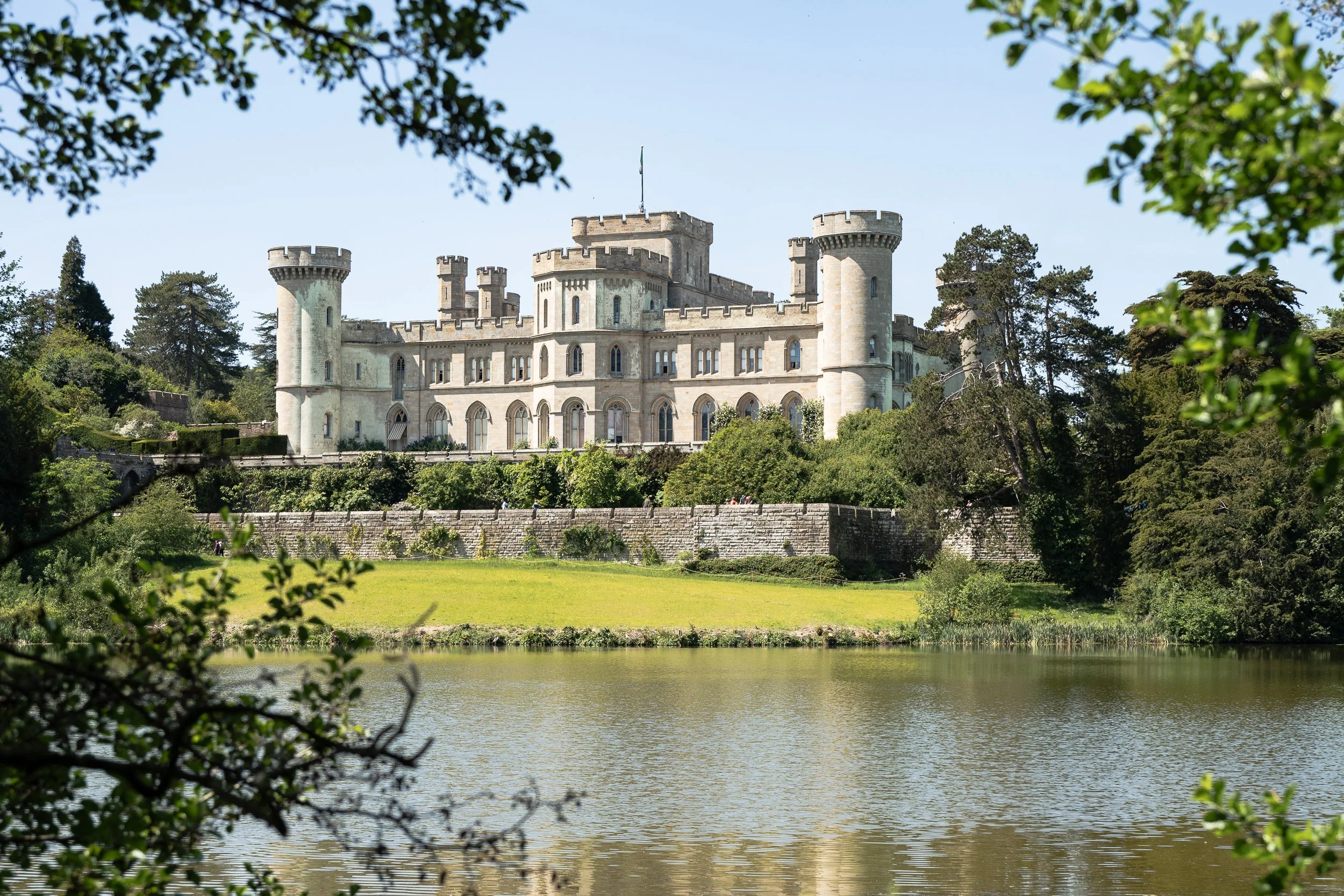 eastnor castle  with lake in front during a family day out taken by Chloe Bower Photography the best worcester based family photographer