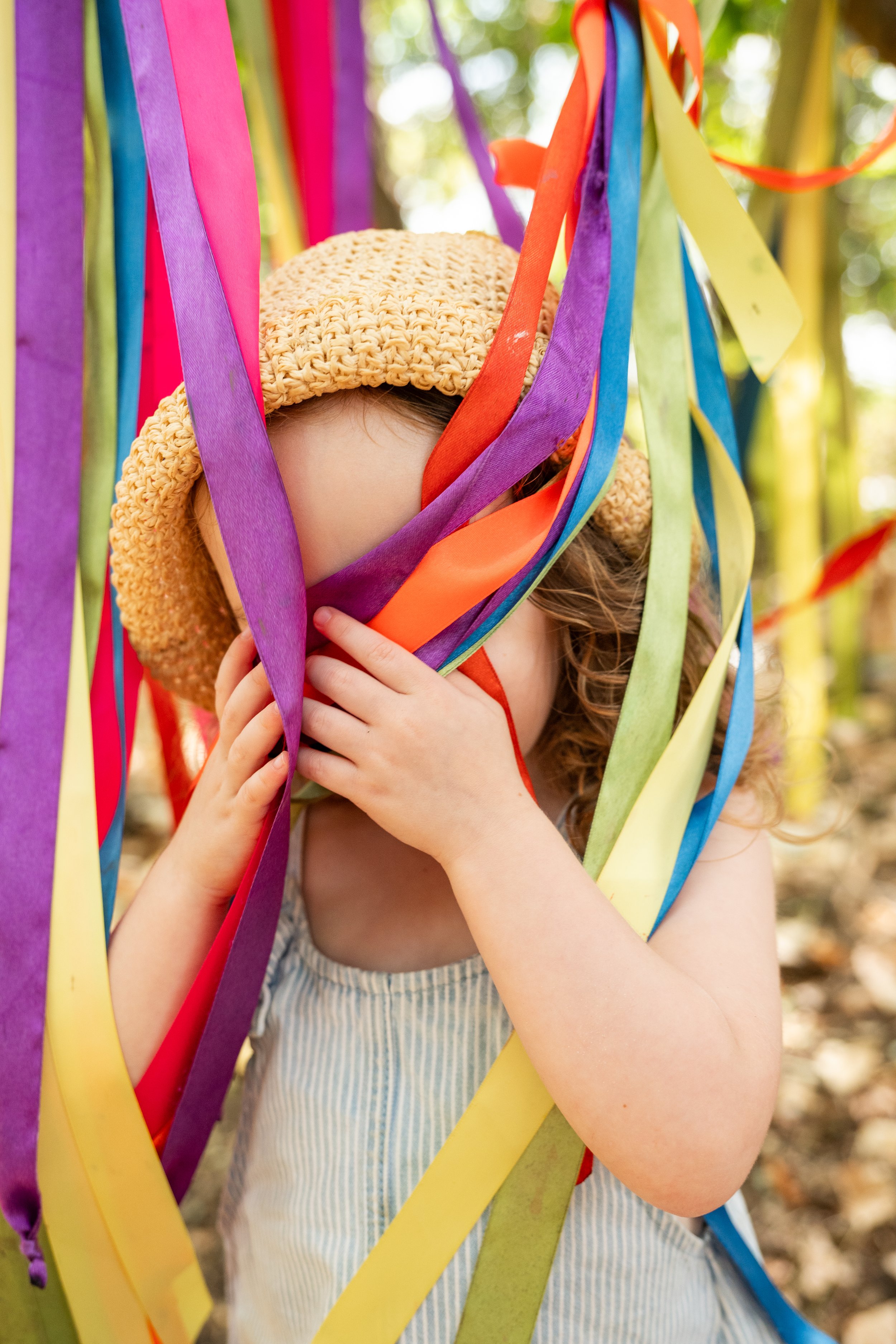 toddler hidden by ribbons during family photoshoot in Tewkesbury, Gloucestershire, UK