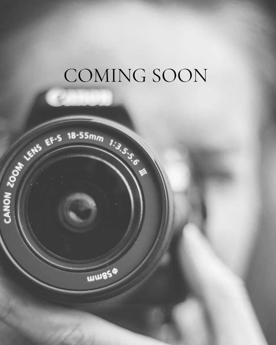 A black and white photo of a Canon camera lens with the text 'COMING SOON' above it.