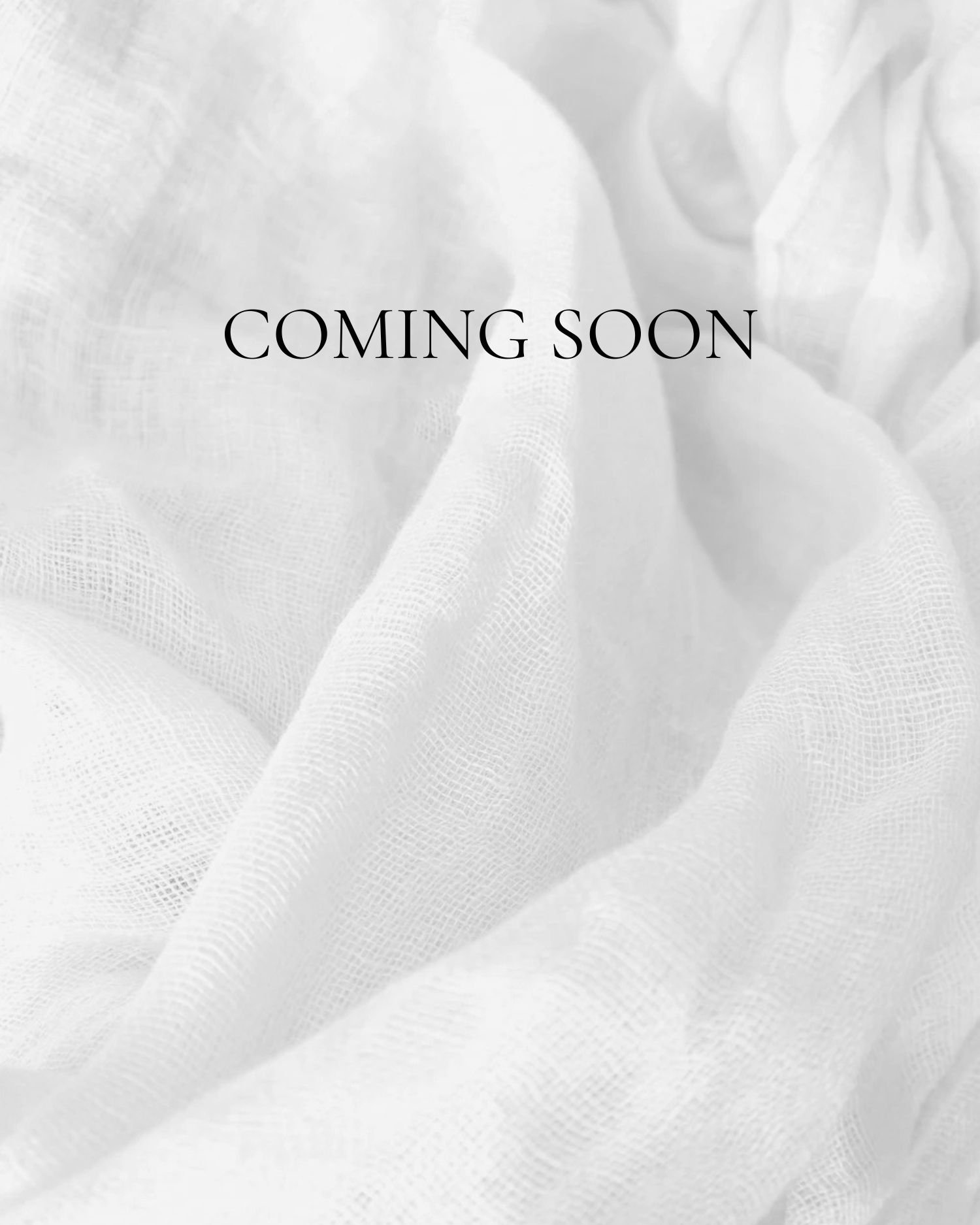 A soft, white fabric with the words 'COMING SOON' in black text in the center.