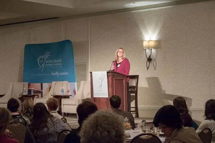 Keynote presenter Kathy Bero engaging with audience at a health conference.