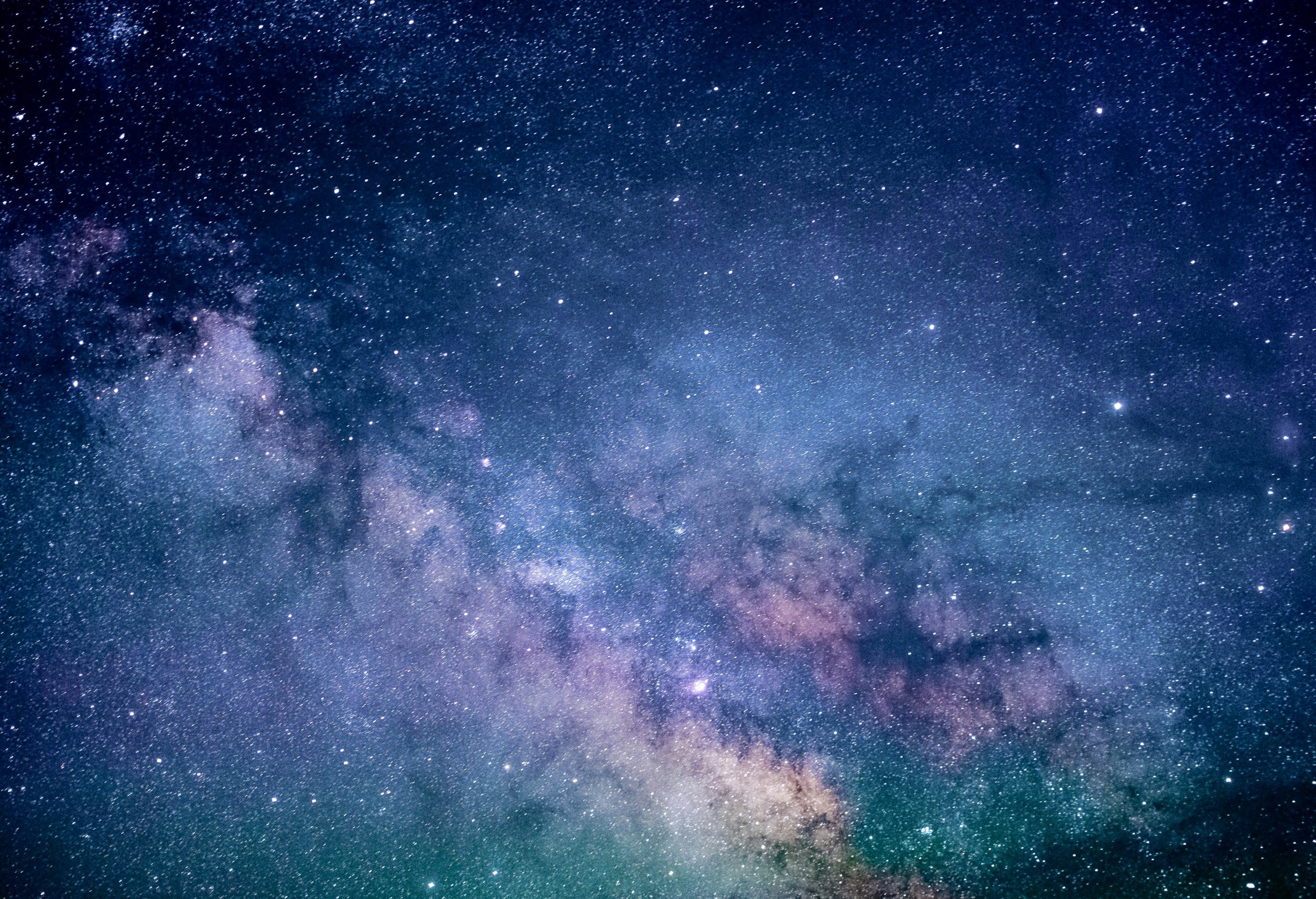 A clear view of the night sky filled with numerous stars and the Milky Way galaxy.