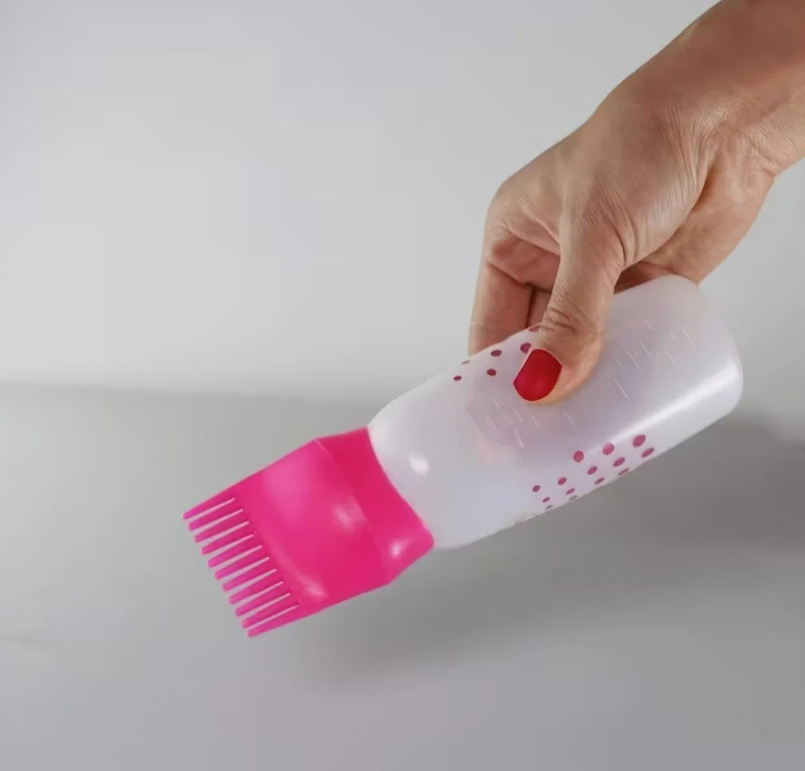 oil root applicator with hand.jpg