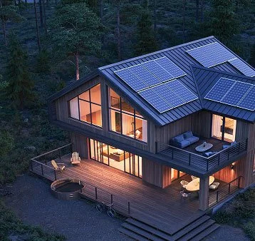 A modern two-story house with solar panels on the roof surrounded by trees, featuring large windows and a wooden deck with outdoor furniture.