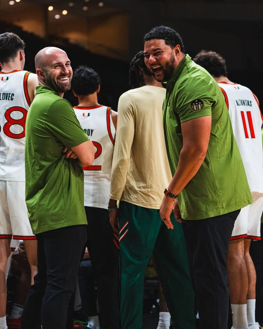 Tommy and staff working with basketball players. 
