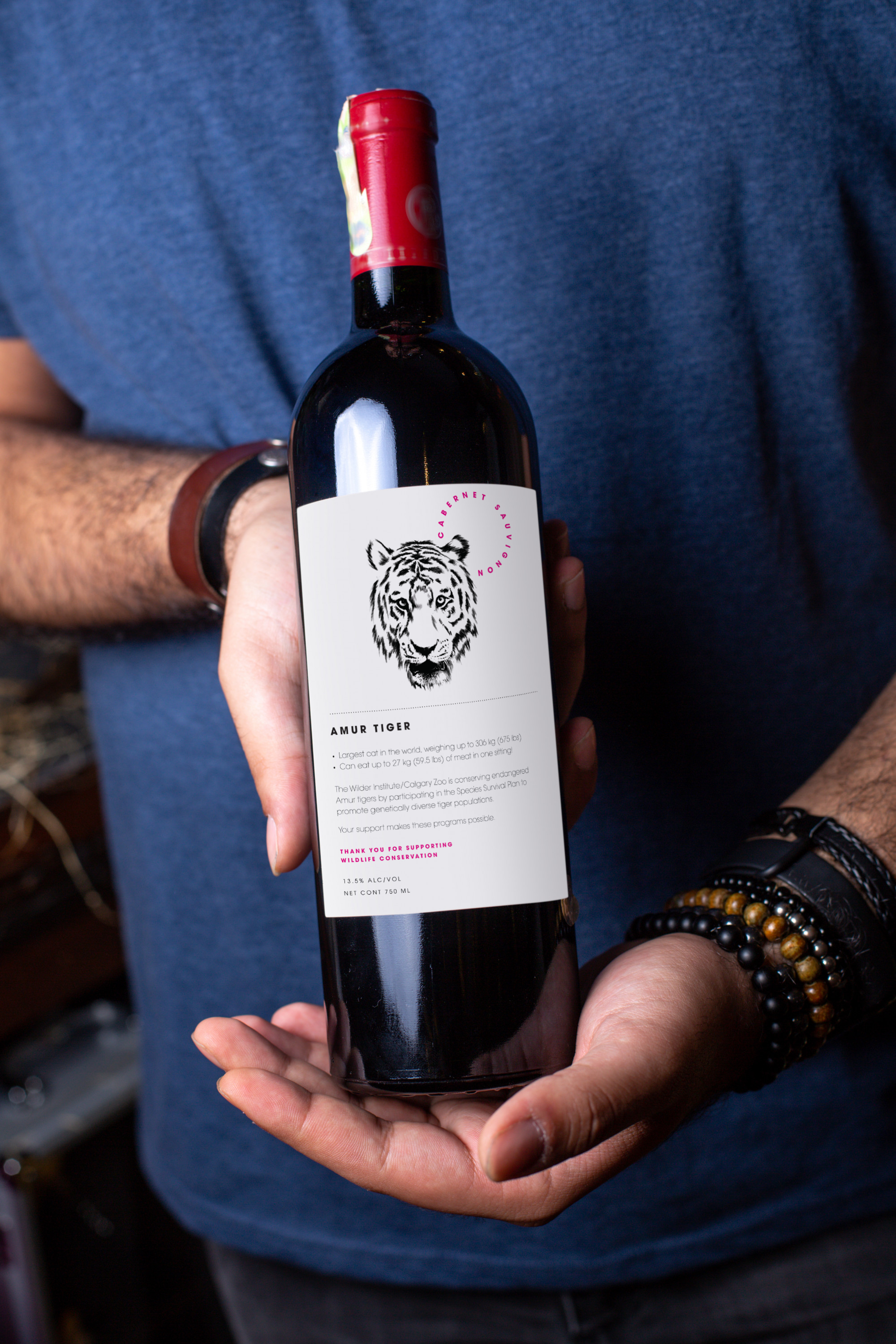 front-view-red-wine-young-man-holding-bottle-red-wine-with-red-cap-alcohol-winery-drink.png